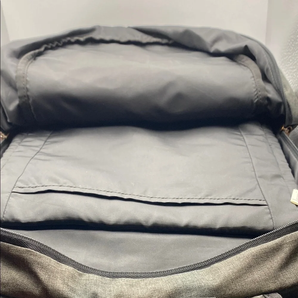 Gray Modern Backpack With Adjustable Straps And Bronze Metal Hardware